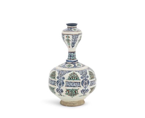 A Minai pottery water bottle Persia, 12th/ 13th Centuryof compressed globular form with slim cylindrical neck surmounted by a