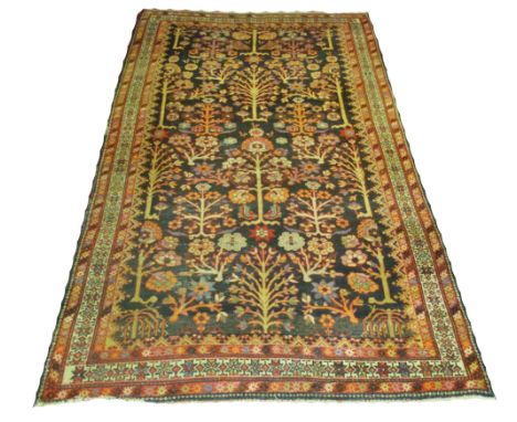 FINE ANTIQUE BAKTIAR CARPET, 294cm x 172cm, noir field of stylised foliage wihtin multiple corresponding bands and borders.