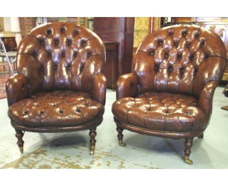 CLUB ARMCHAIRS, a pair, early 20th century, vintage buttoned brown leather, each with rounded back and turned front supports,