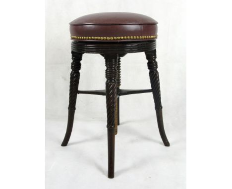 A Revolving Stool:
Regency, mahogany, the later leather top above a carved reeded apron on four reeded outswept legs
H52cm x 