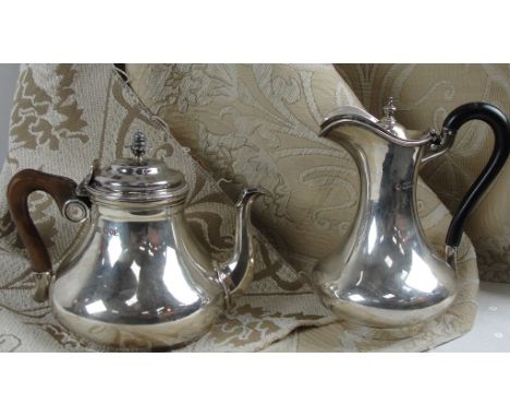 A Silver Tea Pot and Ewer:
Tea pot by Carrington and Co London 1912,with pineapple finial and domed body with wooden handle,1