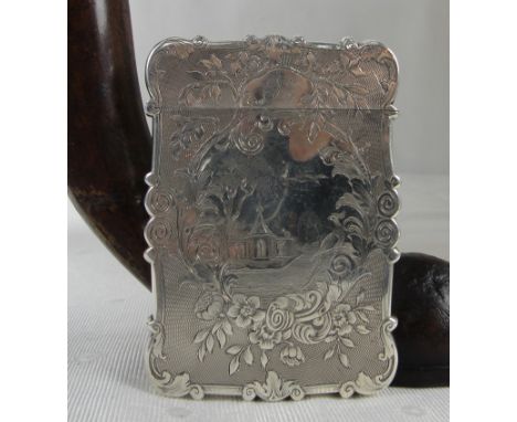 A Victorian Silver Card Case of Shaped Rectangular Form:
a cartouche to the reverse engraved with a vase of flowers surrounde