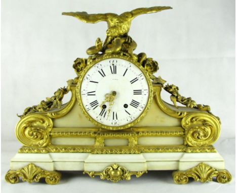 A 19th century French ormolu and marble mantel clock:
The white enamelled dial indistinctly signed with Roman chapter ring an