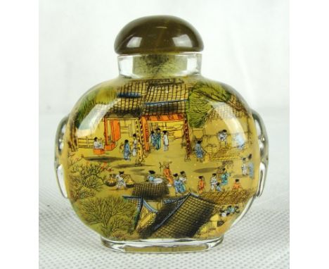 A Chinese inside-painted glass snuff bottle with stopper.
Late 19th century
Meticulously decorated with a continuous scene of