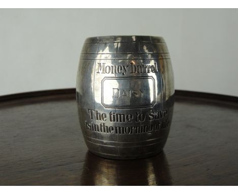 An American Silver Child's Money Box:
In the form of a barrel, the central cartouche engraved "Daisy" above An engraved capti
