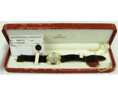 An 18ct gold Omega wristwatch:
An automatic chronometer, gold case and silver dial, with date aperture, hallmarked to the bac