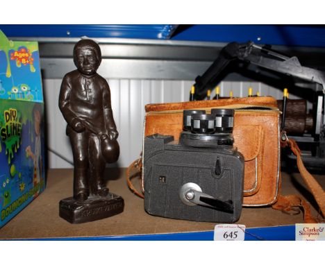 A resin figure and a Prinz cine camera