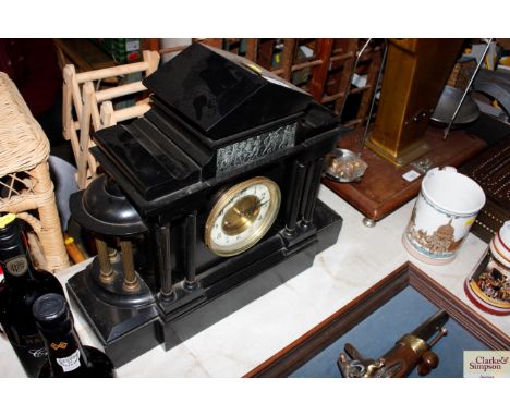 A late Victorian black slate mantel clock