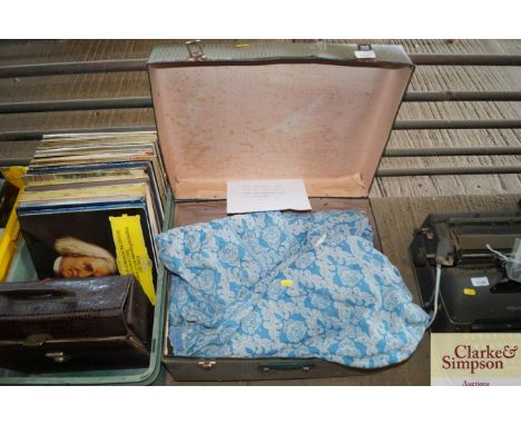 A vintage suitcase containing various curtains and fabrics