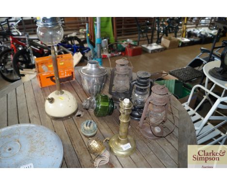 A quantity of hurricane lamps, a Tilley lamp, brass candle sticks, silver plated lamp etc.