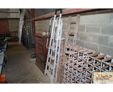 A set of aluminium step ladders together with a wooden step ladder