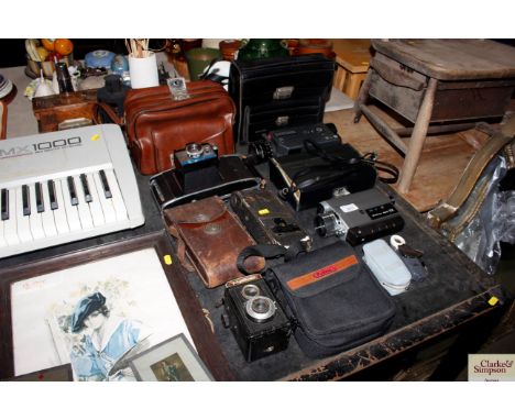 A collection of various cameras and camcorders to include a Polaroid Colorpack 3, an Leicina Super RT1 etc