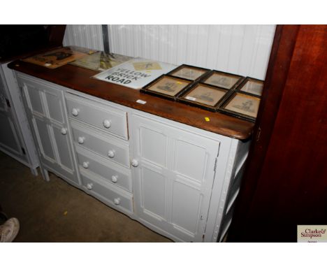 An Ercol Colonial sideboard with a wax top and grey painted base