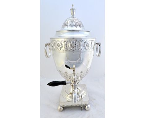 A silver plated large twin handled tea urn, the rim boldly decorated with flower head shaped motifs, the detachable cover wit