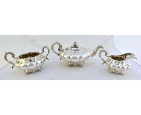 An Irish silver three piece teaset, comprising; a teapot, the hinged lid with a melon finial, a twin handled sugar bowl and a