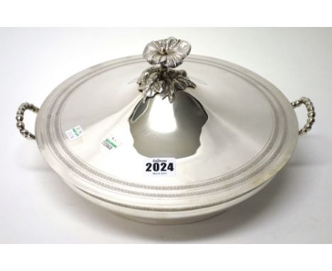 A European twin handled serving dish, with a detachable cover, the base having cast handles and with a decorated rim, detaile