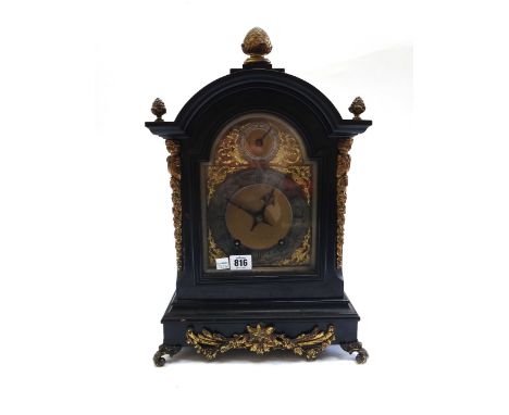 An ebonised and gilt metal mounted mantel clock, late 19th century, with pineapple finial over a domed case, with silvered ch