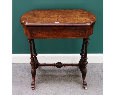 A Victorian marquetry inlaid figured walnut games sewing table, the flip top revealing inlaid playing surfaces over frieze dr