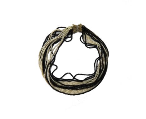 A cultured pearl and black onyx bead multiple strand necklace, on a gold and diamond set clasp, mounted with circular cut dia