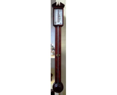 A mahogany and inlaid stick barometer by B.Ronchetti Manchester with broken arch pediment over a silvered plate, pinched wais