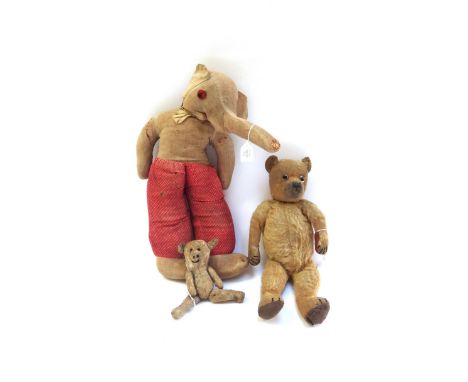 A vintage teddy bear with golden fur, hand stitched snout and jointed limbs, 37cm high, and two further stuffed toy animals (