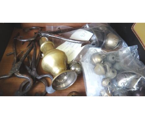 Four 19th century steel sugar cutting tools, a brass sugar sifter and a quantity of crotal bells, four marked 'R.W.' and thre