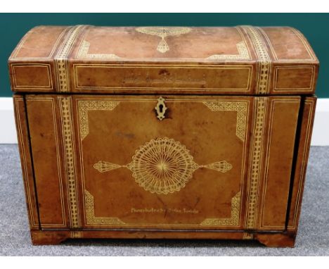 A 17th century style gilt tooled leather dome top trunk, with fitted interior and drop down front, 54cm wide. 