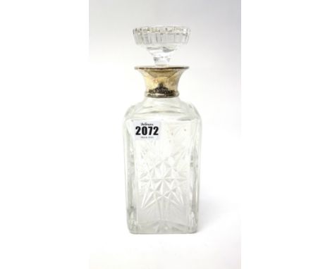 A silver mounted glass decanter, of square section form, with faceted decoration, London 1962. 