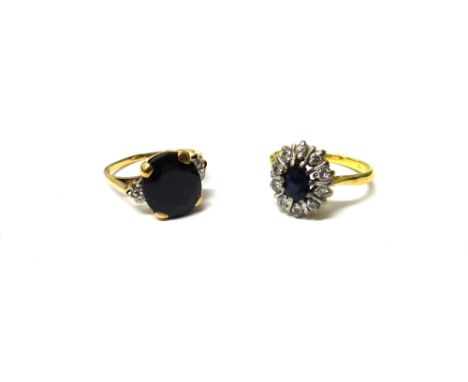 An 18ct gold, sapphire and diamond set oval cluster ring, claw set with the oval cut sapphire at the centre, in a surround of