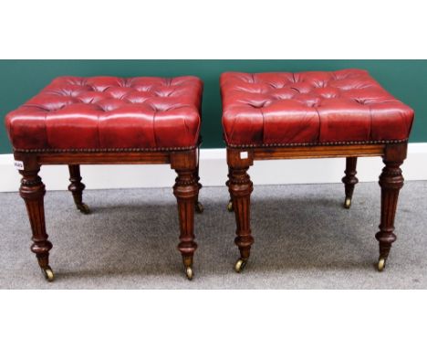 A pair of made up 19th century oak framed footstools, with button rouge leather upholstered seats on tapering fluted supports
