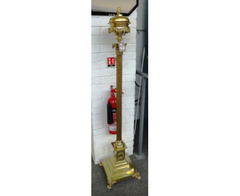 A Victorian brass adjustable standard lamp, circa 1890 of Corinthian column form supporting a foliate embellished brass reser