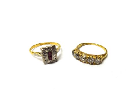 A gold and diamond set five stone ring, mounted with a row of graduated cushion shaped diamonds, the mount decorated with scr