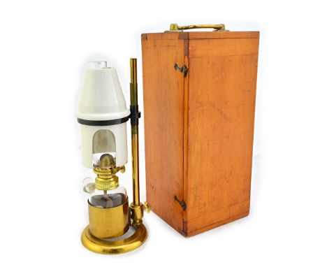 A brass microscope bench lamp, 19th century, by J. H. Steward, with height adjustable pottery shade and glass oil reservoir, 