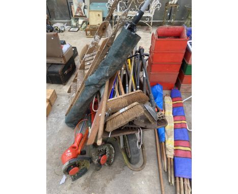 A WHEEL BARROW WITH AN ASSORTMENT OF GARDEN TOOLS TO INCLUDE THREE ELECTRIC STRIMMERS, BRUSHES AND FORKS ETC 