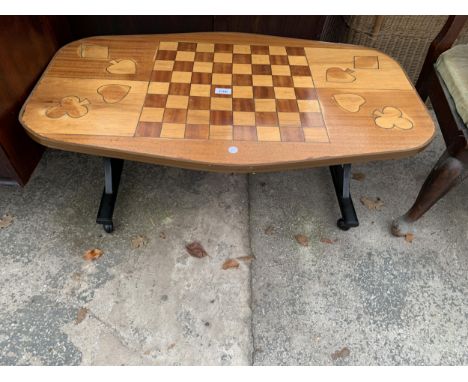 A RETRO TEAK COFFEE/GAMES TABLE WITH INLAID DRAUGHTS BOARD AND CARD SUITS 