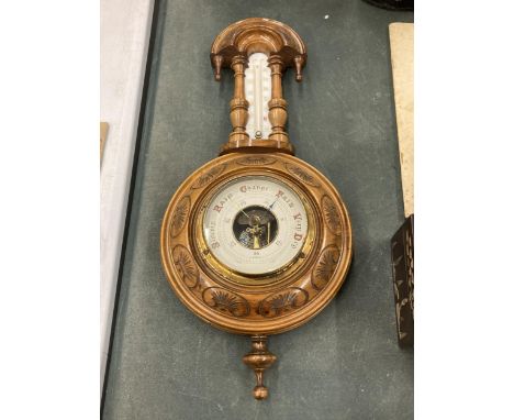 AN ORNATE WALL BAROMETER 