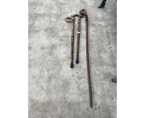 THREE VARIOUS DECORATIVE WOODEN WALKING STICKS TO INCLUDE A HORSE THUMB STICK, AN EAGLE HEAD WALKING STICK AND A FOX 