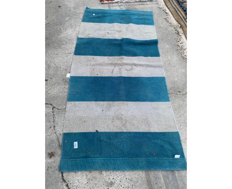 A SMALL BLUE AND BEIGE CARPET RUNNER 