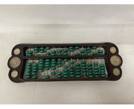 A CHINESE ABACUS WITH MALACHITE COUNTERS AND SILVER COINS 