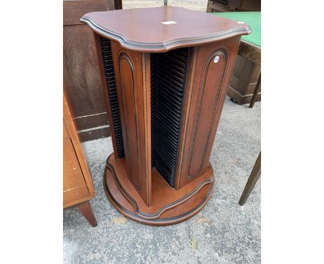 A MODERN REVOLVING CD RACK 