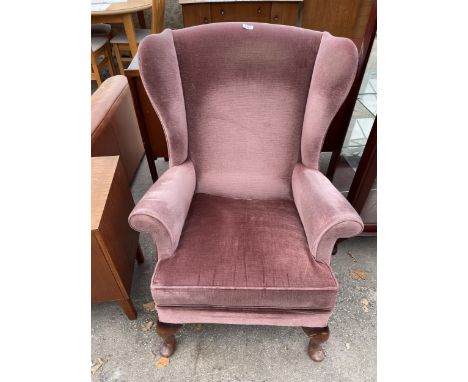 A PARKER KNOLL WINGED FIRESIDE CHAIR ON CABRIOLE LEGS (MODEL NO.720) 