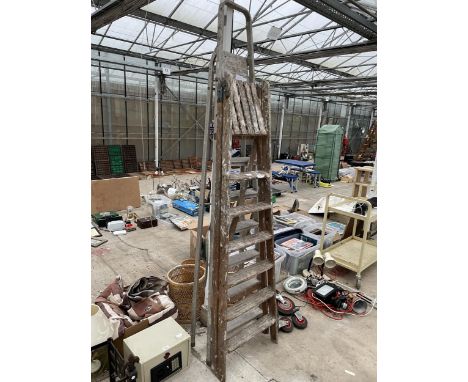 A SIX RUNG VINTAGE WOODEN STEP LADDER AND A FURTHER SEVEN RUNG ALUMINIUM STEP LADDER 
