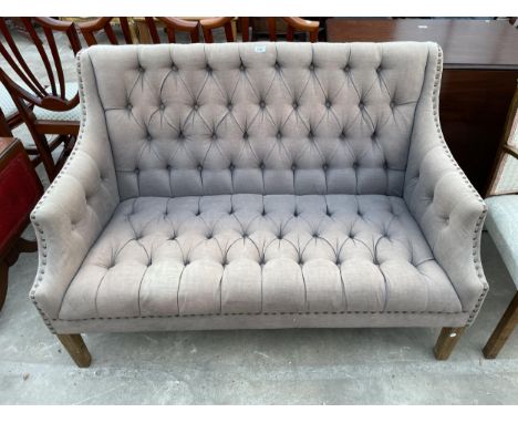 A MODERN HIGH BACK STUDDED AND BUTTONED SOFA 