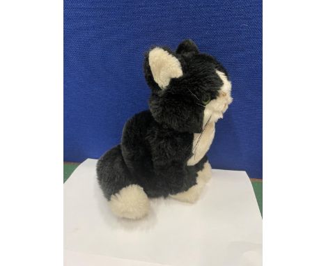 A VINTAGE STEIFF BLACK AND WHITE CAT WITH EAR TAG BUTTON 