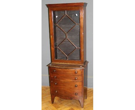 An Edwardian mahogany vitrine of narrow proportions, the moulded cornice over an astragal glazed door enclosing two shelves, 