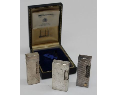 A trio of silver tone Dunhill lighters to include a textured Dunhill&nbsp; London lighter, made in England in original case (