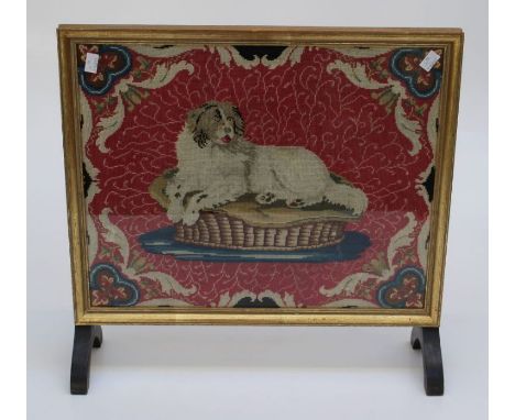 A small 20th century firescreen, set with gros point woolwork of a recumbent spaniel, 52 x 54cm