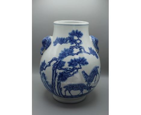 A late 19th / early 20th century Chinese porcelain vase of Hu-shape, with twin elephant mask handles, the body decorated with