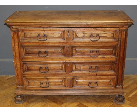 A late 18th / early 19th century Italian walnut commode, the rectangular top over four geometrically moulded long drawers wit