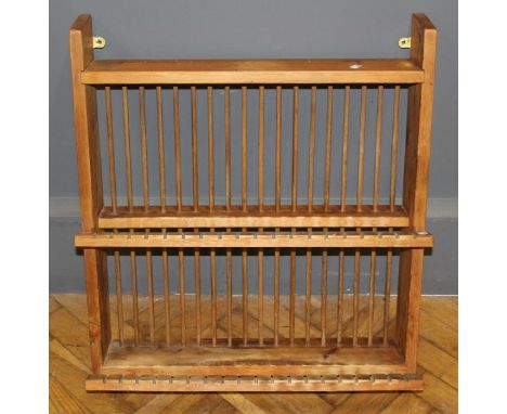 A 20th century pine plate rack, with slotted and stick retainers for thirty eight plates, 71.5 x 64cm